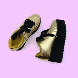 Gold and black platform tennis shoes